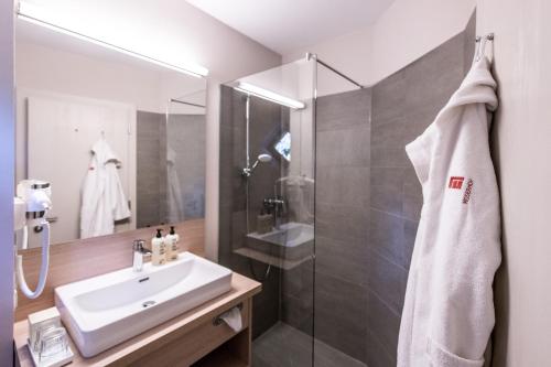 a bathroom with a sink and a shower at Hotel Moserhof in Seeboden