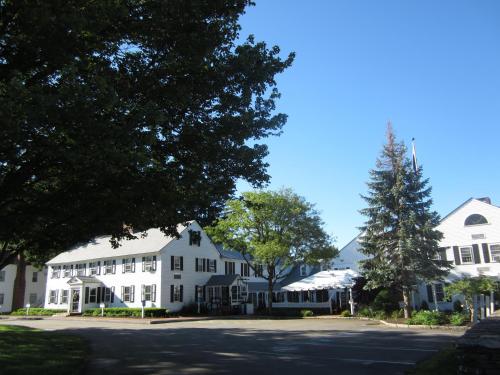 a row of white houses on a street at Publick House Historic Inn and Country Motor Lodge in Sturbridge
