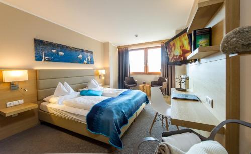 um quarto de hotel com uma cama e uma secretária em Hotel Moserhof em Seeboden