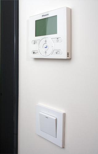 a white microwave on a wall with a safe at NOX Golders Green in London