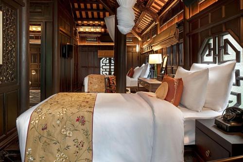 a bedroom with a bed in a train car at Ancient Huế Garden Houses in Hue