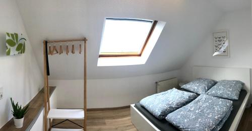 a small bedroom with a bed and a window at Ferienwohnung Xanten in Xanten