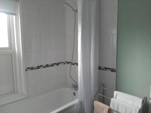 a bathroom with a bath tub and a shower at The Iverna in Eastbourne