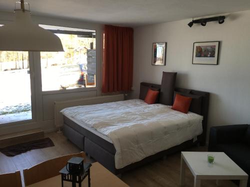 a bedroom with a bed and a large window at Ferienwohnung Marion in Sankt Englmar