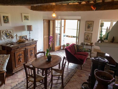 a living room with a table and chairs at Le Pontin in Mane