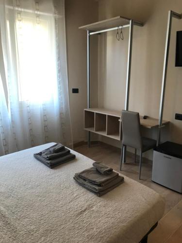 a bedroom with a bed with a mirror and a chair at Riva Reno 4 Rooms in Bologna