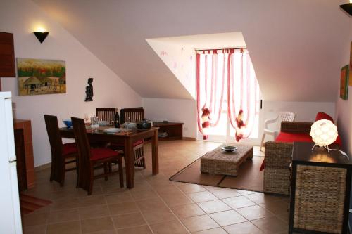 a living room with a table and a dining room at Casa Bahia 11 in Santa Maria