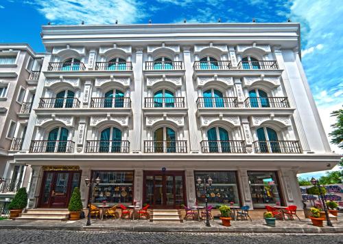 a building with tables and chairs in front of it at The Magnaura Palace Hotel in Istanbul