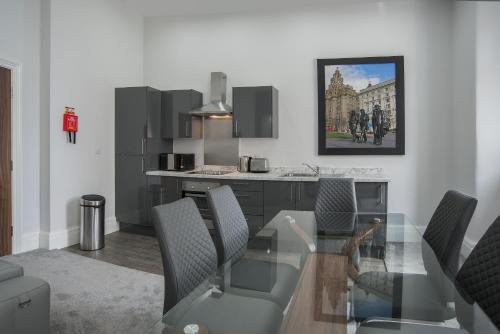 a dining room with a glass table and chairs at The Castle Collection - 42 Castle Street in Liverpool