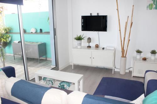 a living room with a couch and a tv at Cactus Home Penthouse in La Garita