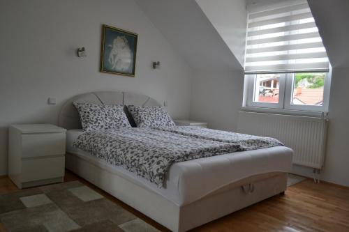 a bedroom with a bed in a room with a window at Apartment Harmony in Višegrad