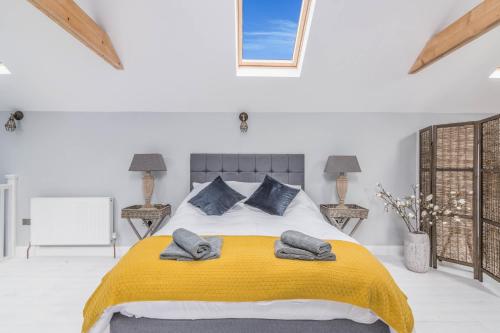 a bedroom with a bed with a yellow blanket at Rainbow House - Entire Place in Lutterworth