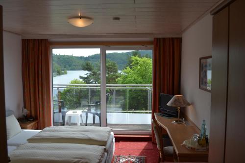 a hotel room with a view of a balcony at Seehotel Andree & Gästehaus Seehof in Waldeck