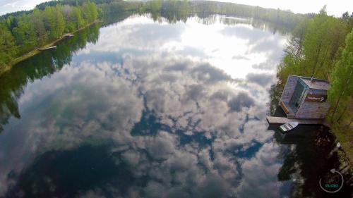 an aerial view of a lake with clouds in the water at TonyResort in Trakai