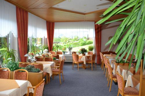 a row of tables and chairs in a restaurant at Seehotel Andree & Gästehaus Seehof in Waldeck