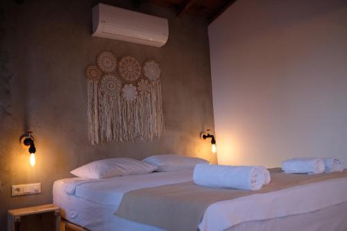 two beds in a room with white sheets and pillows at 8 Pansiyon in Kaş