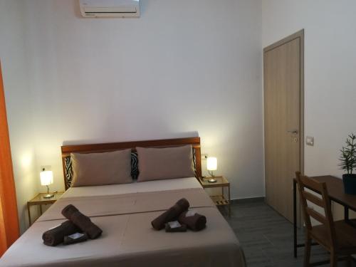 a bedroom with a bed with two slippers on it at CASAMINA in Padova
