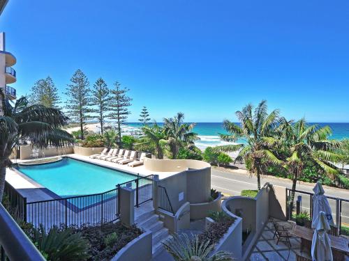 a view of a swimming pool and the beach at Clubb Coolum Beach Resort in Coolum Beach