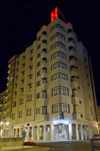 a large building with a red light on top of it at Aparthotel Arenteiro in Carballino