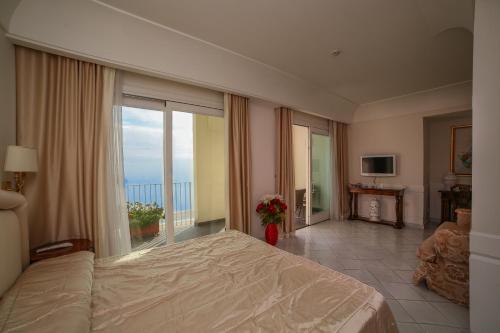 Postel nebo postele na pokoji v ubytování Hotel Villa Fraulo