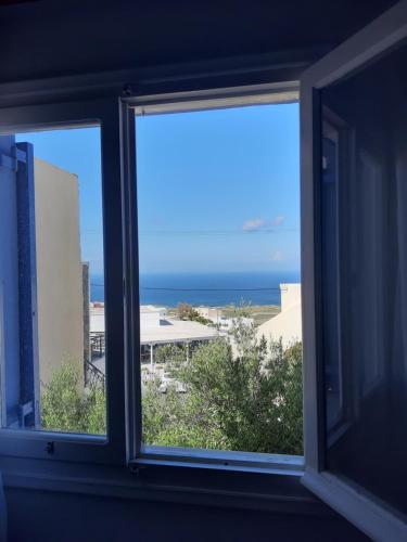 a window with a view of the ocean at Katerina Kafieri Apartments in Firostefani