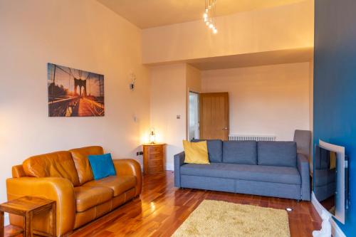 a living room with a couch and a couch and a table at Apartment No 1 - The Old Red King Pub, Whitefield, Manchester in Manchester