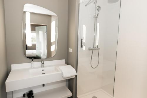 a bathroom with a sink and a shower at ibis Nantes Saint Herblain in Saint-Herblain