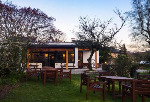 a group of tables and chairs in front of a building at Bower House Inn in Eskdale
