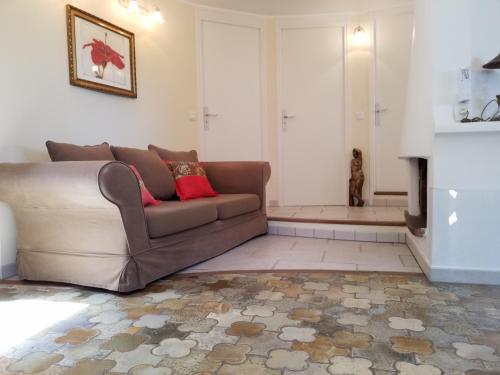 a living room with a couch and a fireplace at Haus mit Garten über der Bucht von Cannes in Vallauris