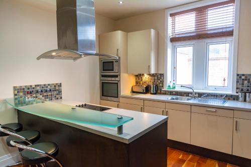 a kitchen with a pool table in the middle of it at Apartment No 1 - The Old Red King Pub, Whitefield, Manchester in Manchester