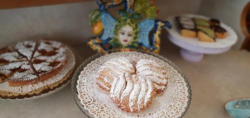 a table with two cakes and a plate of food at Ines bed and breakfast in Giardini Naxos