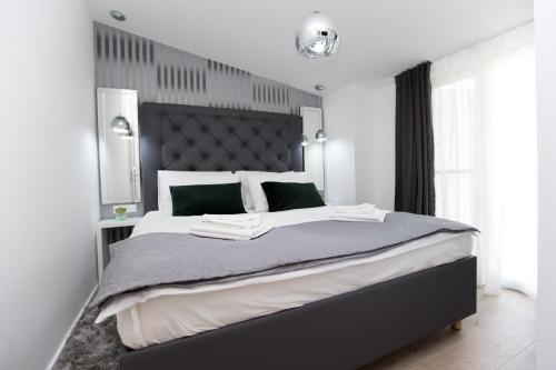 a bedroom with a large bed with a large headboard at Luxury Apartments Mia in Podstrana