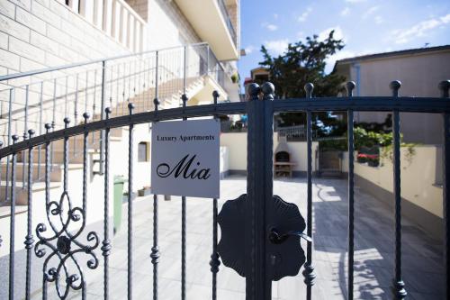 a sign on a gate in front of a building at Luxury Apartments Mia in Podstrana