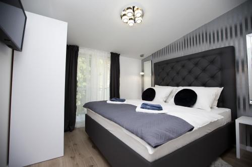 a bedroom with a large bed with a black headboard at Luxury Apartments Mia in Podstrana