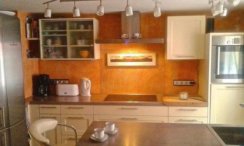 a kitchen with white cabinets and a counter top at Grüne Franziska in Ettenheim