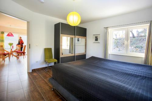 a bedroom with a bed and a table and chairs at Hainhof Gaestewohnungen in Bad König