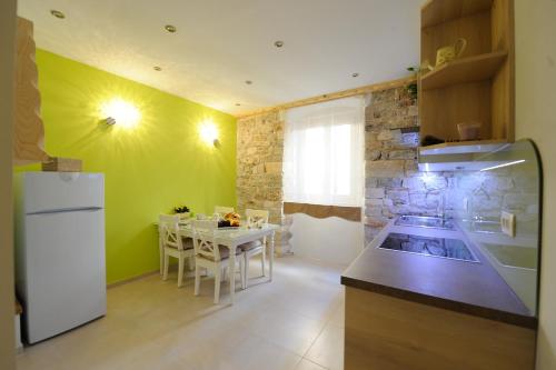 a kitchen with a white refrigerator and a table at Desiderata Studio Apartment in Split