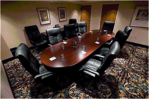 a conference room with a wooden table and black chairs at Staybridge Suites Williamsville Buffalo by IHG in Williamsville