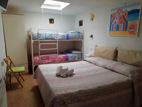 a bedroom with a bed with a stuffed animal on it at B&B Celestina Ischia in Ischia