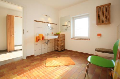 a bathroom with a sink and a toilet at Hainhof Gaestewohnungen in Bad König