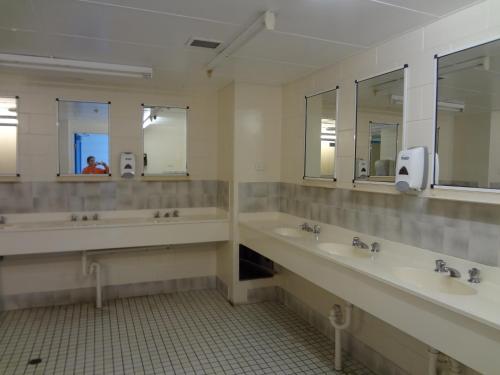 a bathroom with two sinks and a mirror at Adventurers Backpackers in Townsville