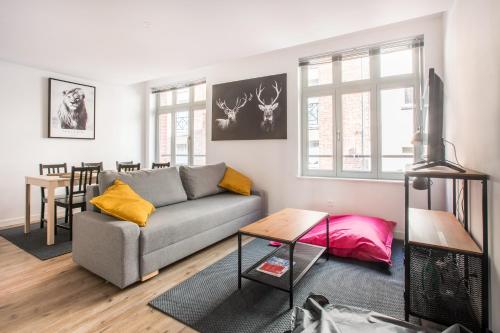 a living room with a couch and a table at 3 Chambres au cœur du vieux Lille in Lille
