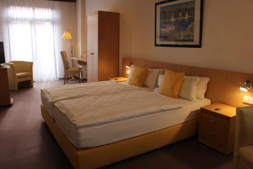 a bedroom with a large bed in a room at Hotel Rebstock in Ohlsbach