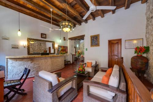 a living room filled with furniture and a large window at Casa Del Curato in Cartagena de Indias