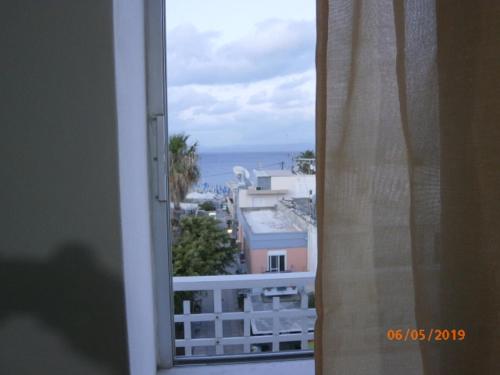 a view of the ocean from a window at Popi Studios in Kos Town