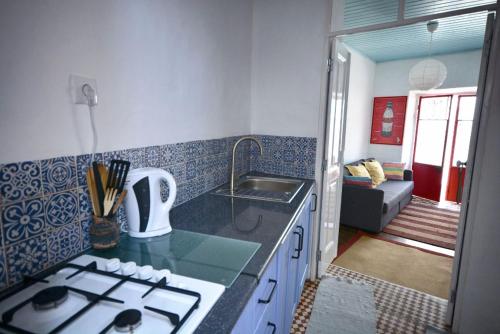a kitchen with a stove top oven in a room at Traditional House in Historical Center of Faro in Faro