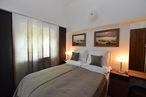 Postel nebo postele na pokoji v ubytování Apartmani FAMILY