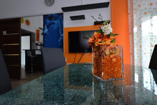 a vase filled with flowers sitting on a table at Apartmani FAMILY in Sveti Filip i Jakov