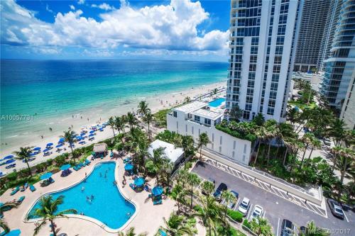 an aerial view of a resort with a pool and the beach at Tides Apt on Hollywood Beach in Hollywood