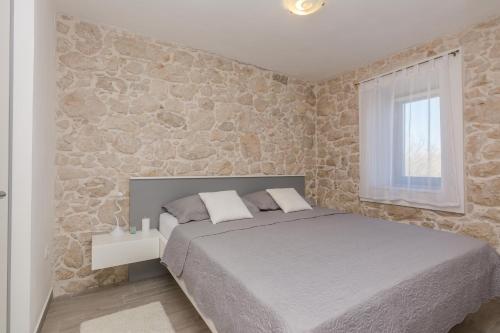 Posteľ alebo postele v izbe v ubytovaní Apartmani Mustaća dvori